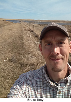 Bruce Toay siting grasslands